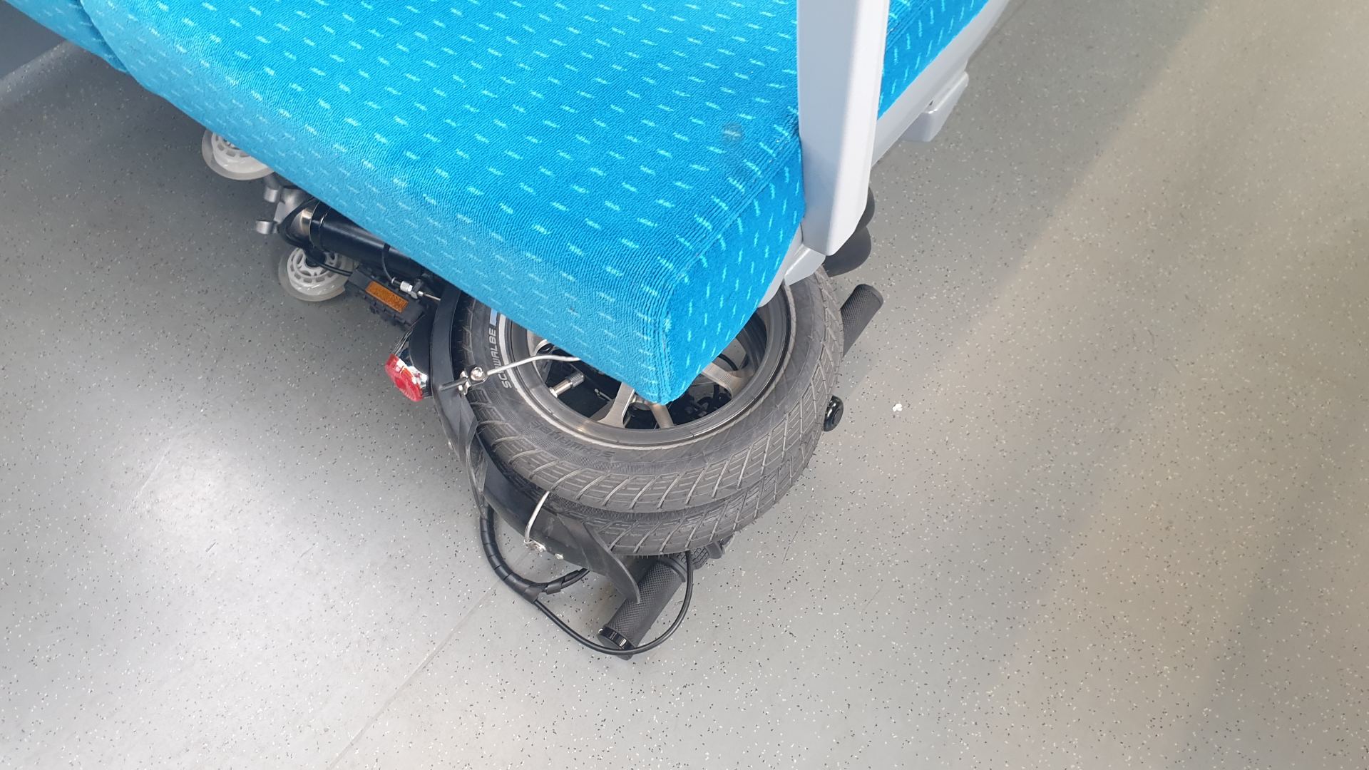 Folding-Kwiggle-under-the-seat-in-the-train